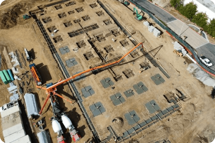 Aerial view of foundation pad layout with concrete pump and footing locations