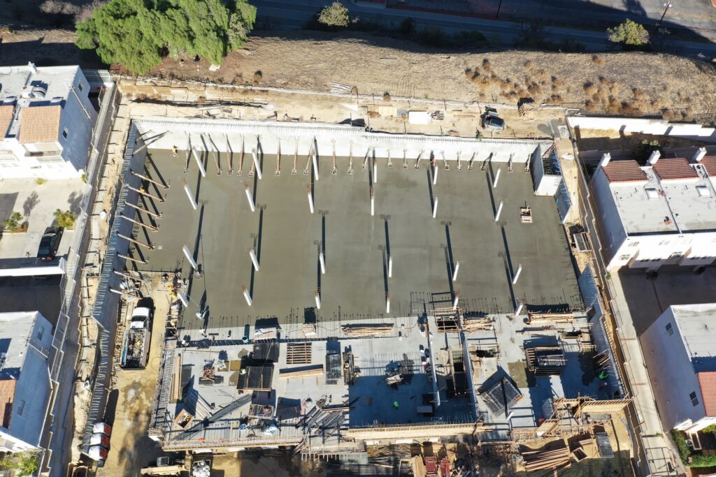 Aerial view of large concrete slab pour with evenly spaced structural columns
