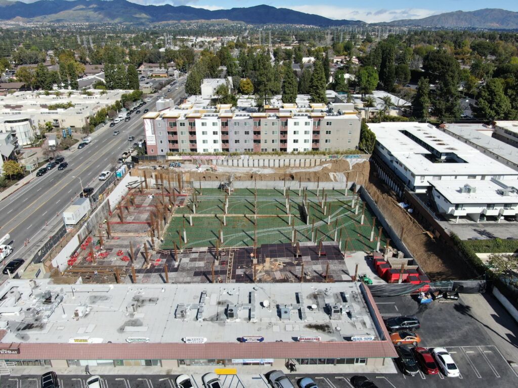 Aerial view of residential podium construction with rebar and formwork installed